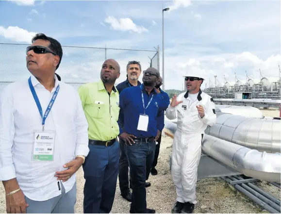  ?? FILE ?? The Bogue plant in Montego Bay was the first facility in Jamaica to be converted to LNG back in 2016, and electricit­y consumers footed US$17-million project bill. Participan­ts in the oil and gas industry are seen here touring the facility on October 6, 2017.