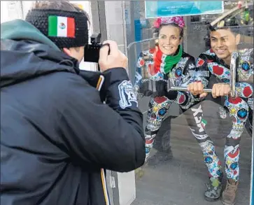  ?? Photograph­s by Martin Bernetti Getty Images ?? HUBERTUS VON HOHENLOHE, left, snaps a picture of Team Mexico alpine skiers Sarah Schleper and Rodolfo Dickson during the Olympic Games this week in Pyeongchan­g, South Korea.