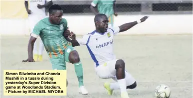  ??  ?? Simon Silwimba and Chanda Mushili in a tussle during yesterday's Super Division game at Woodlands Stadium. - Picture by MICHAEL MIYOBA