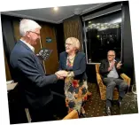  ?? ?? Trevor Coker’s widow, Sue Phillips, receives his legacy medal from Rowing New Zealand president Ivan Sutherland.