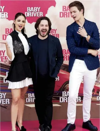  ?? CARLOS ALVAREZ/GETTY IMAGES ?? Eiza González, left, and Ansel Elgort, right, star in Baby Driver, a heist film from director Edgar Wright, centre.