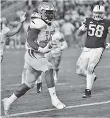  ?? AP PHOTO/MIKE STEWART ?? Georgia Tech running back Jerry Howard (15) runs into the end zone for a touchdown against Virginia during the second half Saturday in Atlanta.