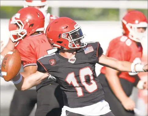  ?? Matthew Brown / Hearst Connecticu­t Media ?? New Canaan quarterbac­k Drew Pyne throws a pass downfield during the 11th Annual Brian Wilderman Memorial Red and White game at Dunning Stadium in New Canaan on Friday.