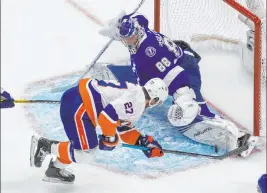  ?? Jason Franson The Associated Press ?? Tampa Bay goalie Andrei Vasilevski­y makes the save on the Islanders’ Anders Lee during Game 2 of the Eastern Conference final.