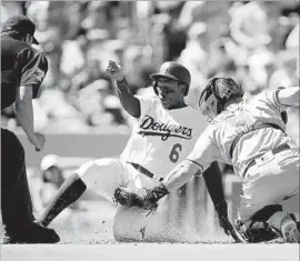  ?? Luis Sinco Los Angeles Times ?? RIGHT FIELDER Curtis Granderson beats Nick Hundley’s tag to score on Yasmani Grandal’s second-inning sacrifice fly. Grandal also homered in the fourth.