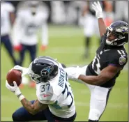  ?? (AP/Nick Wass) ?? Tennessee Titans safety Amani Hooker (37) intercepts a pass intended for Baltimore Ravens wide receiver Devin Duvernay during the second half Sunday in Baltimore. The Titans won 30-24 in overtime to give the Ravens their second consecutiv­e loss.