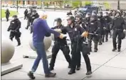  ?? Mike Desmond Associated Press ?? A MAN identified as Martin Gugino is shoved by police during a protest on Thursday in Buffalo, N.Y.