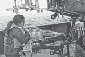  ?? SUSAN VON THUN ?? Anela Choy, a professor at the Scripps Institutio­n of Oceanograp­hy, collects deep-sea samples of water to test for plastic pollution.
