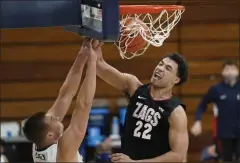  ?? ASHLEY LANDIS - THE ASSOCAITED PRESS ?? Gonzaga forward Anton Watson (22) dunks against Pepperdine forward Jan Zidek, left, during the second half of an NCAA college basketball game Saturday, Jan 30, 2021, in Malibu, Calif.