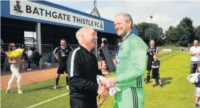  ??  ?? Man of the match Andy Carlin picks up his award from Peter McGrillen