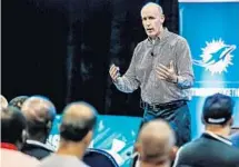  ?? SUBMITTED PHOTO ?? Miami Dolphins Head Coach Joe Philbin talks to area youth and high school coaches at a recent four-day clinic at Nova Southeaste­rn University.