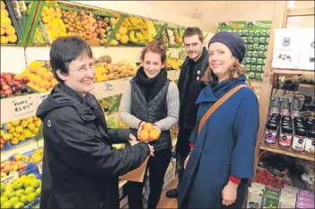  ?? Picture: David Wardle. ?? Robyn MacNeil, second from left, serves Totally Locally organisers Sarah Stuart, Ben Barron and Karen Small.