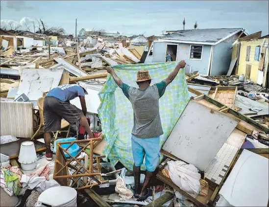  ?? Ramon Espinosa Associated Press ?? HURRICANE DORIAN unleashed destructio­n on the Bahamas. Climate activist Greta Thunberg was among those paying attention. “We are in the beginning of a mass extinction and all you can talk about is money and fairy tales of eternal economic growth,” she scolded the world. “You have stolen my dreams and my childhood.”