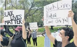  ?? WAYNE K. ROUSTAN/SOUITH FLORIDA SUN SENTINEL ?? More than 50 residents hold up signs and chanted “Black Lives Matter” Saturday at Pine Tree Park in West Palm Beach, joining protests against police violence across the country.