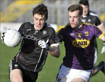  ??  ?? Wexford defender Jim Rossiter challenges Gerard O’Kelly-Lynch of Sligo.