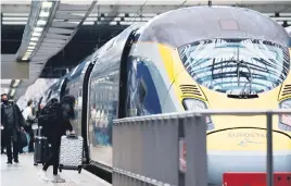  ?? Picture: AFP ?? LESS PEOPLE. Passengers board a Eurostar train in London. Many are now opting to take the plane between London and Paris.