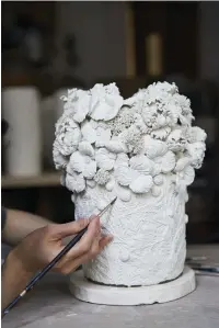  ??  ?? Right Each sprig is slightly different as Hitomi carves extra detail into each one once she has taken it out of the mould; she then carefully bends them to create a sense of movement.