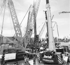  ??  ?? Cranes and other constructi­on equipment are seen at CONEXPO-CON/AGG convention at the Las Vegas Convention Center in Las Vegas, Nevada. US employers likely maintained a brisk pace of hiring in February and boosted wages for workers, which is expected...