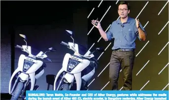  ?? —AFP ?? BANGALORE: Tarun Mehta, Co-Founder and CEO of Ather Energy, gestures while addresses the media during the launch event of Ather 450 (C), electric scooter, in Bangalore yesterday. Ather Energy launched the electric scooter along with Ather 340, a...