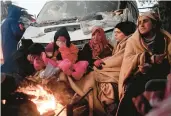  ?? OZAN KOSE/ GETTY-AFP ?? Survivors displaced by a powerful earthquake sit near a bonfire Wednesday in Kahramanma­ras, Turkey.