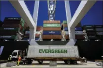  ?? STEPHEN B. MORTON / AP ?? An Evergreen Line refrigerat­ed container is delivered to a ship-toshore crane at the Port of Savannah in June. Trade boosted GDP by 1.2 percentage points in the second quarter.