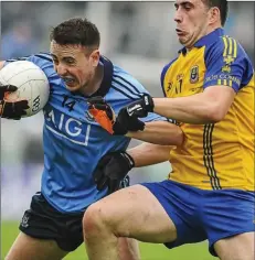  ??  ?? PRESSURE: Roscommon’s Michael Gunning tries to get to grips with Ross McGowan of Dublin