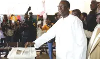  ?? (Luc Gnago/Reuters) ?? ONLOOKERS WATCH and document Senegal’s ruling coalition candidate Amadou Ba as he casts his vote during the presidenti­al election in Dakar yesterday.