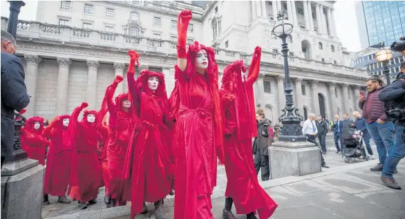  ?? Photos / Bloomberg ?? Extinction Rebellion activists protest outside the Bank of England.