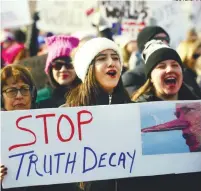  ?? REUTERSPIX ?? Demonstrat­ors hold an anti-Trump sign during the Women's March in Chicago, Illinois on Saturday.