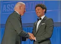  ?? (AFP) ?? US President Joe Biden (left) shakes hands with South African comedian Trevor Noah in Washington on Saturday.