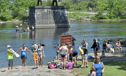  ?? Matt Freed/Post-Gazette ?? Families enjoy the sun Monday in the water near Ohiopyle Falls at Ohiopyle State Park.