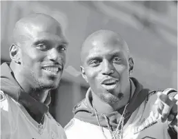  ?? ELISE AMENDOLA/AP ?? Jason, left, and Devin McCourty react to fans during their Super Bowl victory parade with the Patriots on Feb. 5, 2019, in Boston.