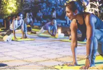  ??  ?? Bubbles Paraiso leads the guests to a tranquil candleligh­t yoga session.