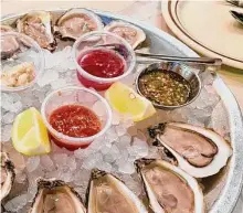  ?? Photos by Alison Cook/Staff ?? Yummy Seafood & Oyster Bar features a wide variety of East Coast oysters at happy hour prices.