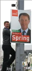  ??  ?? Labour’s Arthur Spring hangs a poster in Rock Street, Tralee