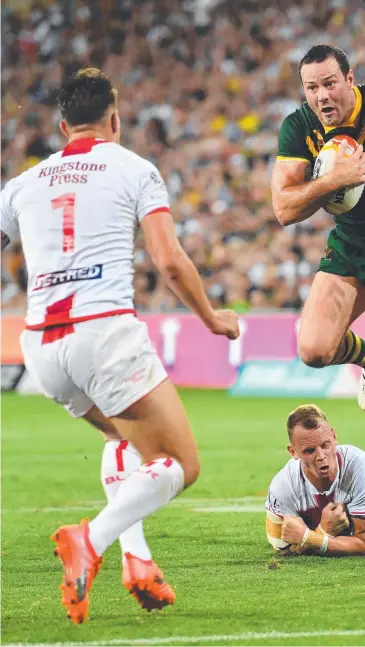  ??  ?? Boyd Cordner gets out of a tackle to score during last night’s World Cup Final between Australia and