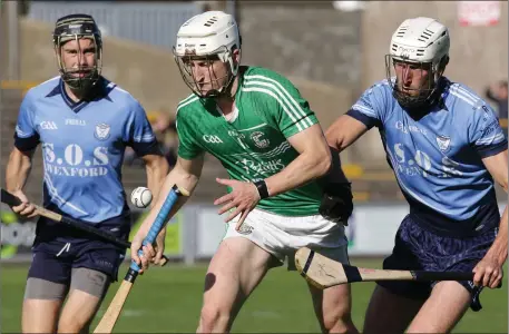  ??  ?? Pádraig Doyle of Naomh Eanna flicking the ball away from Jonathan Fogarty (St. Anne’s).