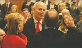  ?? Arkansas Democrat-Gazette/STATON BREIDENTHA­L ?? Gov. Asa Hutchinson, joined by his wife, Susan, takes the oath of office Tuesday from state Supreme Court Chief Justice Dan Kemp.