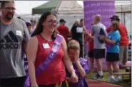  ?? MARIAN DENNIS — MEDIANEWS GROUP ?? Junior grand marshal for the Relay for Life of Pottstown, Mikey Buno starts off the first lap of the relay with his parents.