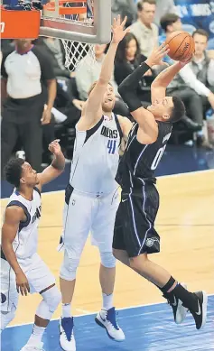  ??  ?? Aaron Gordon (right) of the Orlando Magic takes a shot against Dirk Nowitzki of the Dallas Mavericks in the first half at American Airlines Centre in Dallas, Texas. — AFP photo