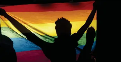  ?? Photo: Contribute­d ?? Brave… People carry a gay pride rainbow flag in Lagos, Nigeria. The country passed a law against “samesex marriage” in 2014. Homosexual­ity is punishable by 10 to 14 years in prison.