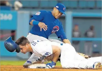  ?? Robert Gauthier Los Angeles Times ?? COREY SEAGER of the Dodgers slides into second base ahead of the tag by Chicago’s Javier Baez in the third inning. Seager singled in Andrew Toles on the play.