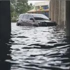  ?? Photo by Lucian Perkins for The Washington Post ?? An SUV is submurged in Houston flood waters caused by Hurricane Harvey.