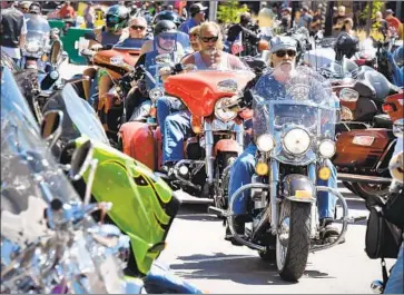  ?? Jim Holland Associated Press ?? BIKERS fill Main Street in Sturgis, S.D., for the city’s motorcycle rally, expected to attract 250,000 people through next weekend. South Dakota has no mask mandates, and some worry the event will spread COVID-19.