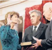  ?? ALEX BRANDON/AP 2015 ?? Then-Vice President Joe Biden administer­s the oath of office to Sen. Lisa Murkowski at a mock swearing-in. Verne Martell, center, is Murkowski’s husband.