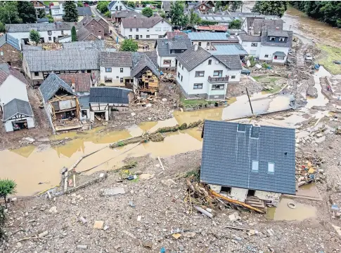  ??  ?? DISASTER: Houses near the River Ahr in Germany were swept away as roads turned into raging torrents.