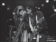  ?? The Associated Press ?? PLAY ON: Steven Tyler, left, and Joe Perry of Aerosmith perform at the Whisky A Go Go on April 8, 2014, in Los Angeles. Though others are canceling events and concerts after the terror attacks at an Ariana Grande concert in England, Aerosmith has...