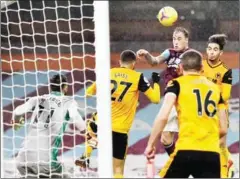  ?? POOL/AFP ?? Burnley striker Ashley Barnes (centre) jumps to head in their first goal in the Premier League match against the Wolves.