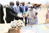  ?? ?? Angel of Hope Foundation patron First Lady Dr Auxillia Mnangagwa hands over books to teaching staff in Kanyemba for the benefit of schools in the area