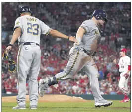  ?? JEFF ROBERSON — THE ASSOCIATED PRESS ?? Milwaukee’s Daniel Vogelbach is congratula­ted by first base coach Quintin Berry while rounding the bases after hitting a two-run home run off St. Louis pitcher Miles Mikolas.